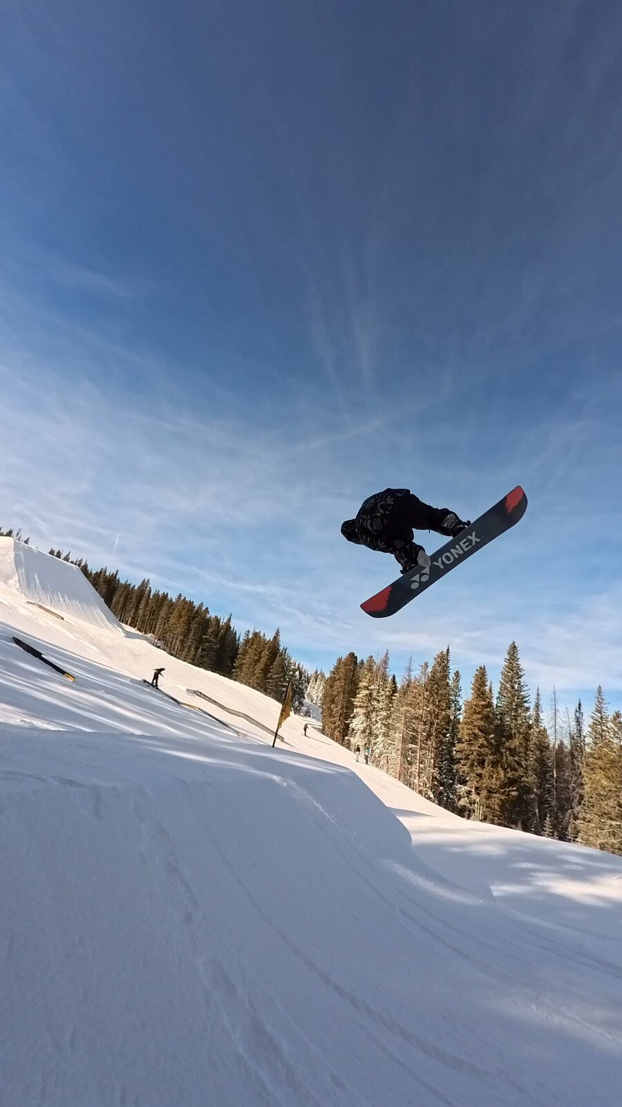 Snowboarder throwing a trick off a jump
