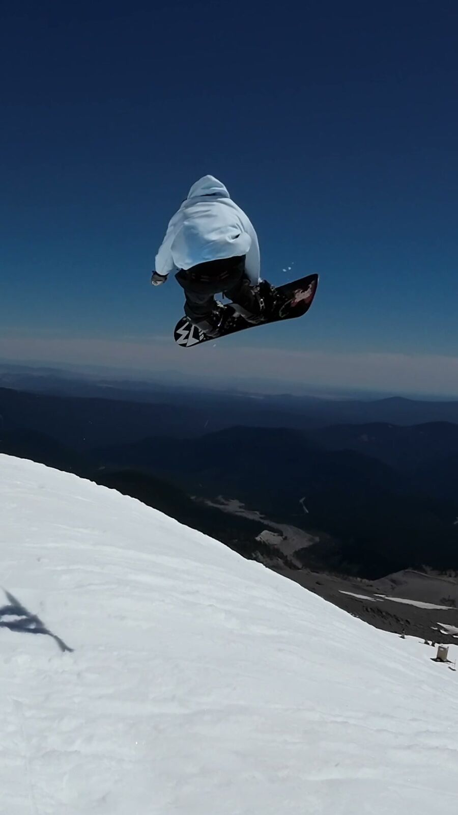 Rider in the air above the summer glacier